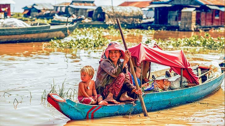 Local mother with her children on the river 