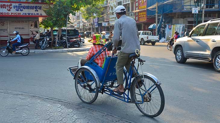 Local man rides tourist in rickshaw
